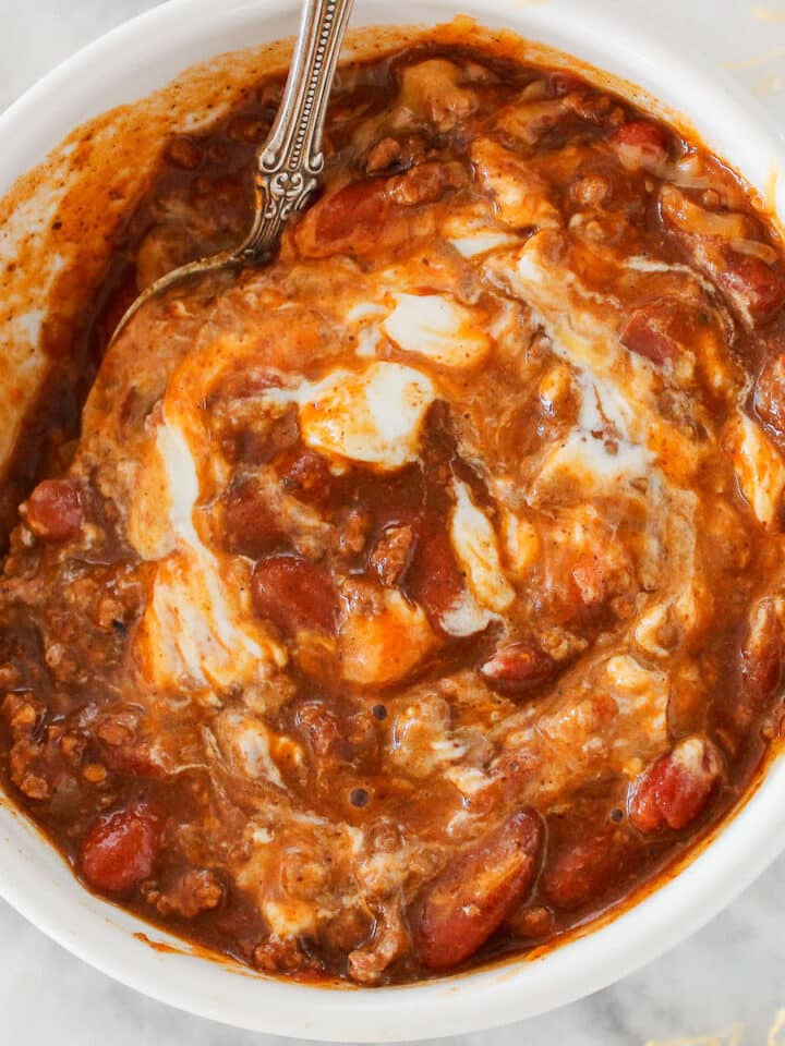 Pinot Noir Chili in bowl with sour cream and cheese
