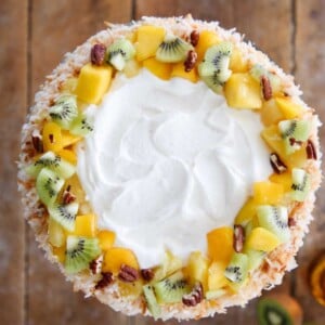 Tropical Fruit Trifle decorated with fresh fruit pecans coconut.