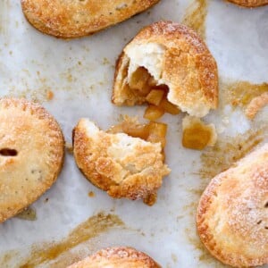 apple hand pie broken open on parchment paper.