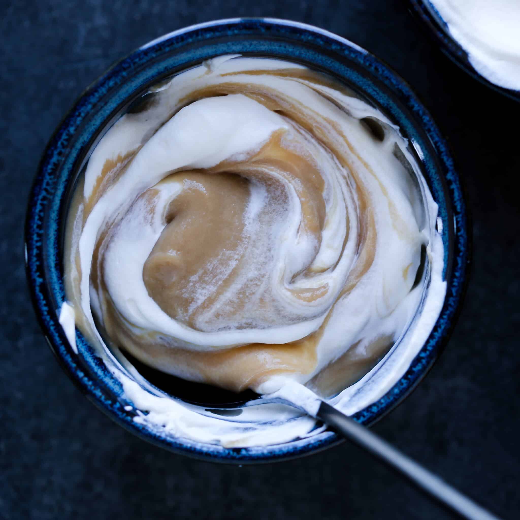 Light brown butterscotch pudding swirled with white whipped cream.
