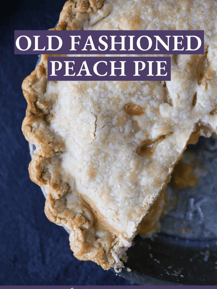 Old Fashioned Peach Pie in a pie tin complete with perfectly crimped edges.