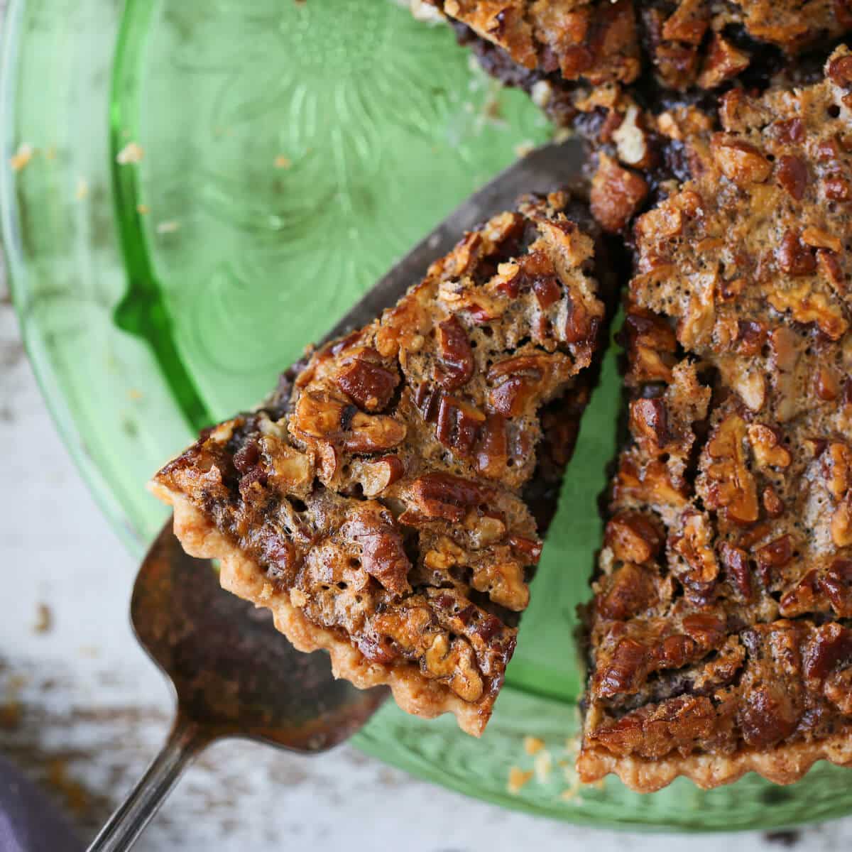 Bourbon Chocolate Pecan Tart slice green depression glass cake plate