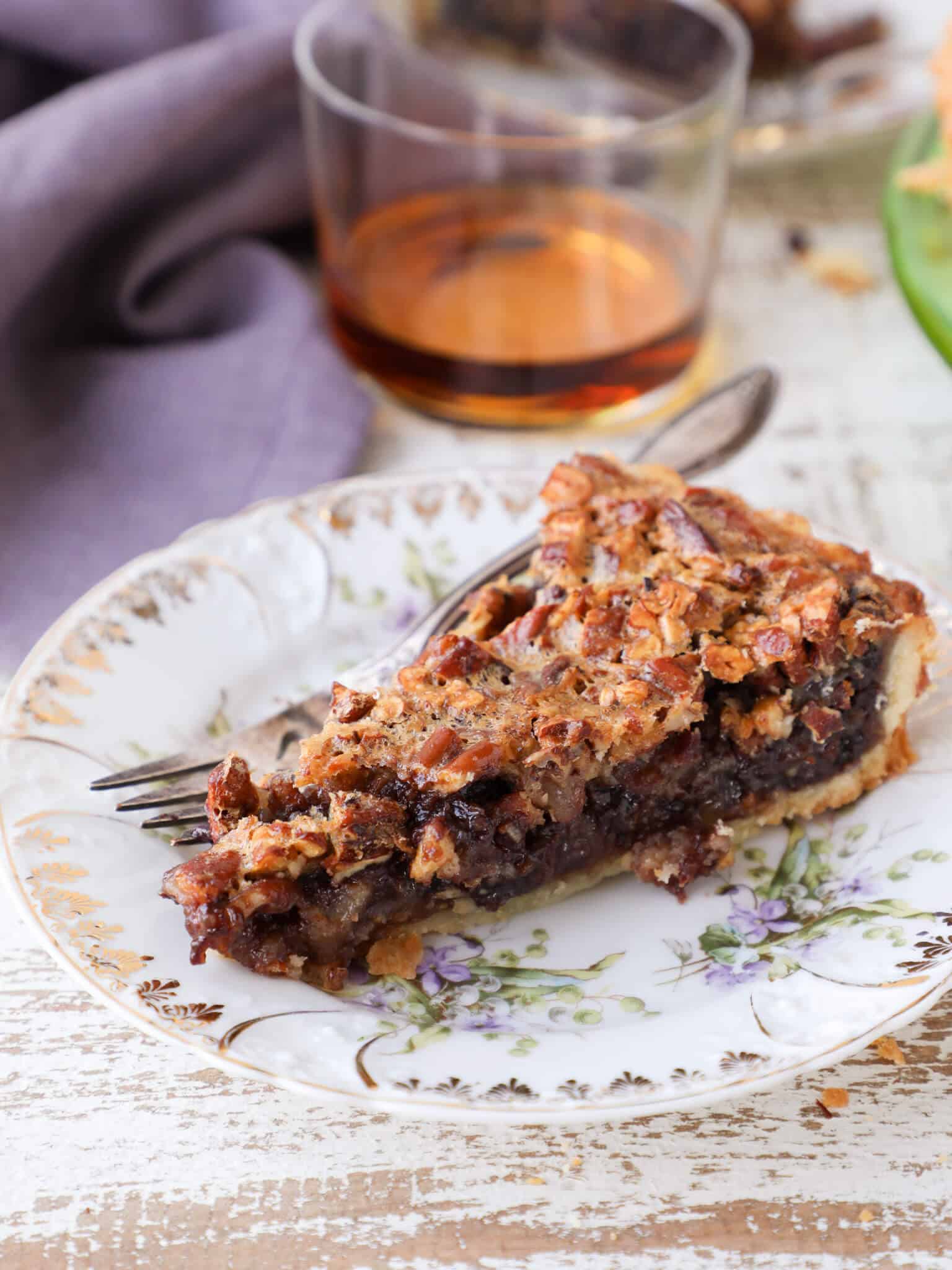 Bourbon Chocolate Pecan Tart slice with purple napkin