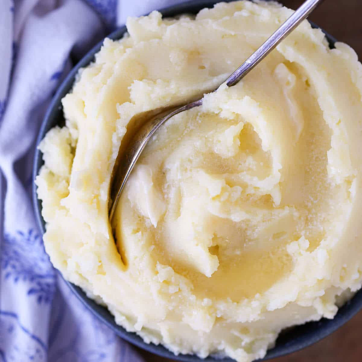Creamy Mashed Potatoes Recipe with vintage spoon in blue bowl