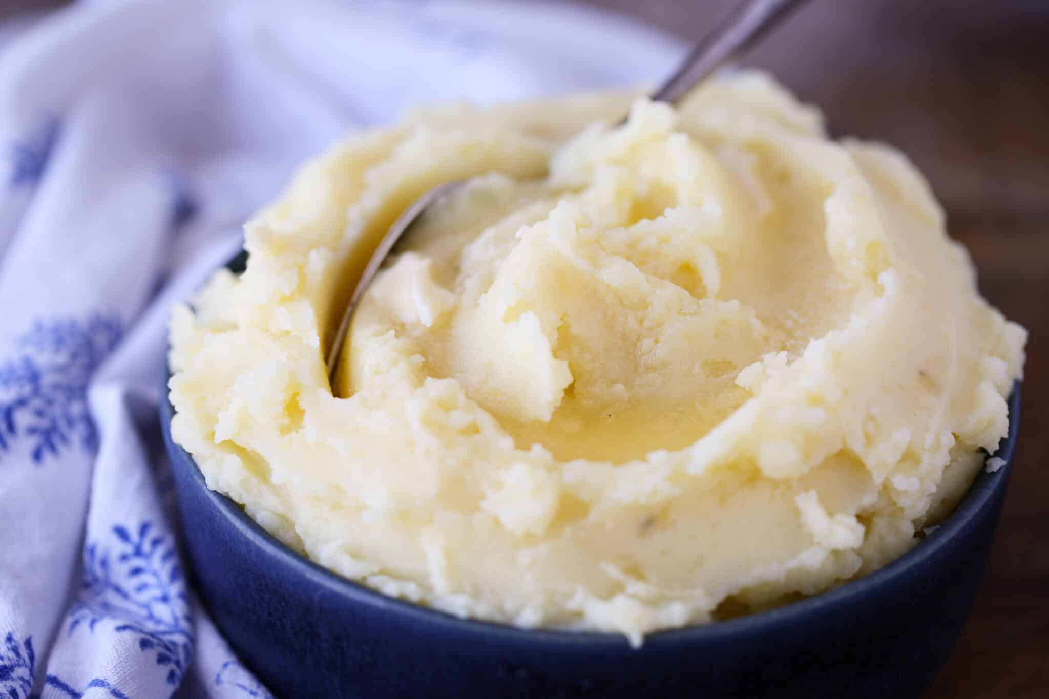 Creamy Mashed Potatoes Recipe in blue bowl with blue napkin