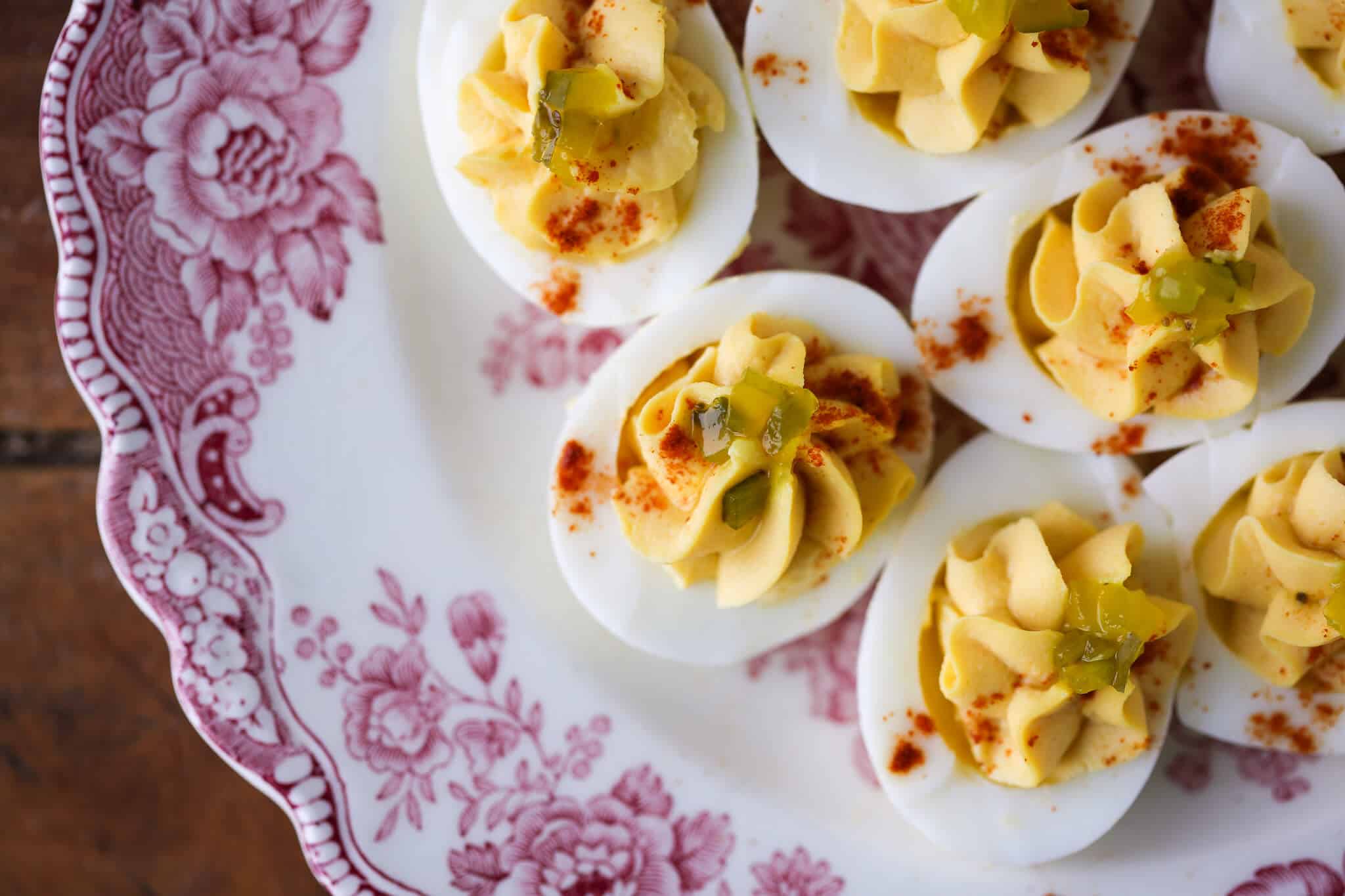 Perfectly coiffed deviled egg filling on white hard boiled egg whites.