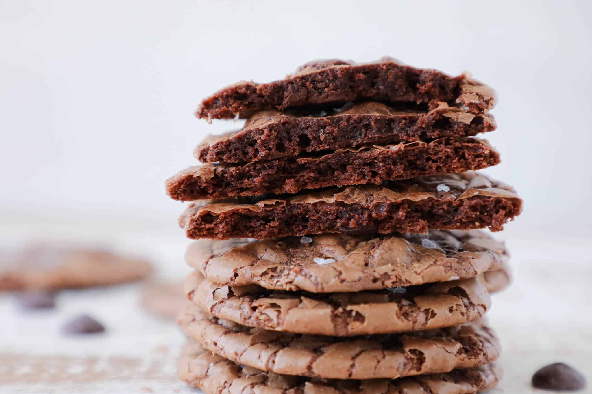 Brownie cookies in a stack with some cracked open.