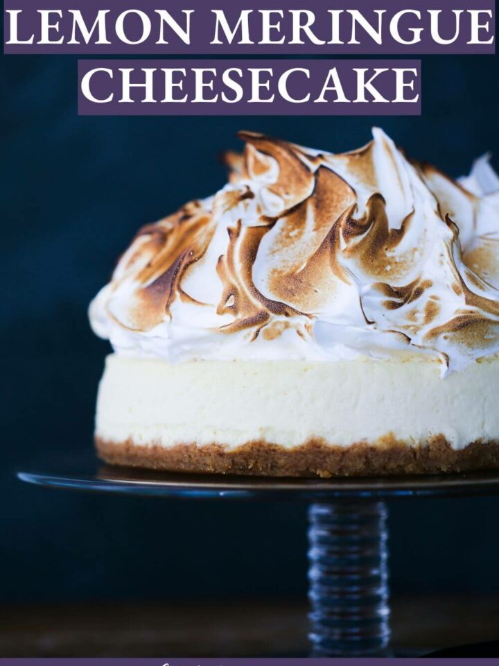 cheesecake with meringue on top on glass cakestand.