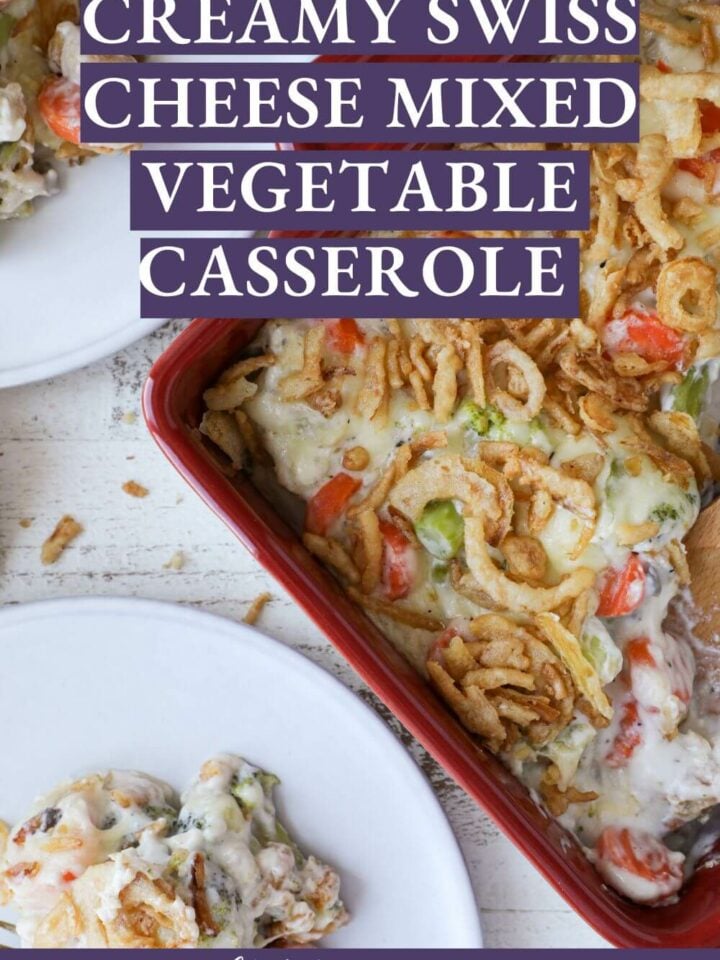 Mixed vegetable casserole served from a red dish onto two white plates.
