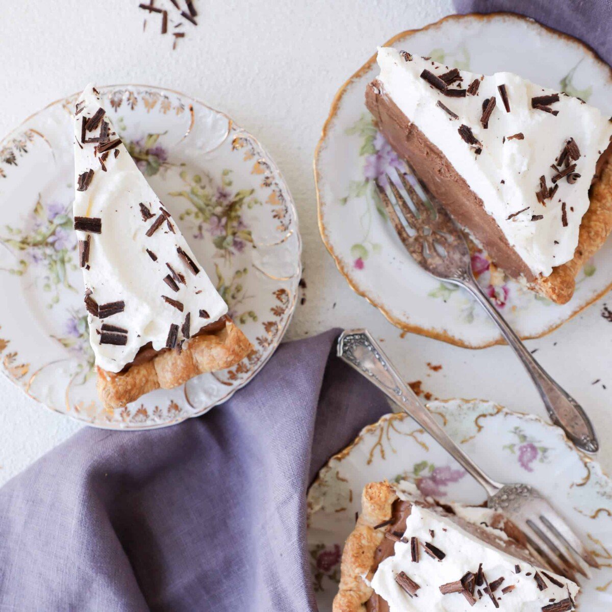 French Silk Pie slices on 3 plates White Background.