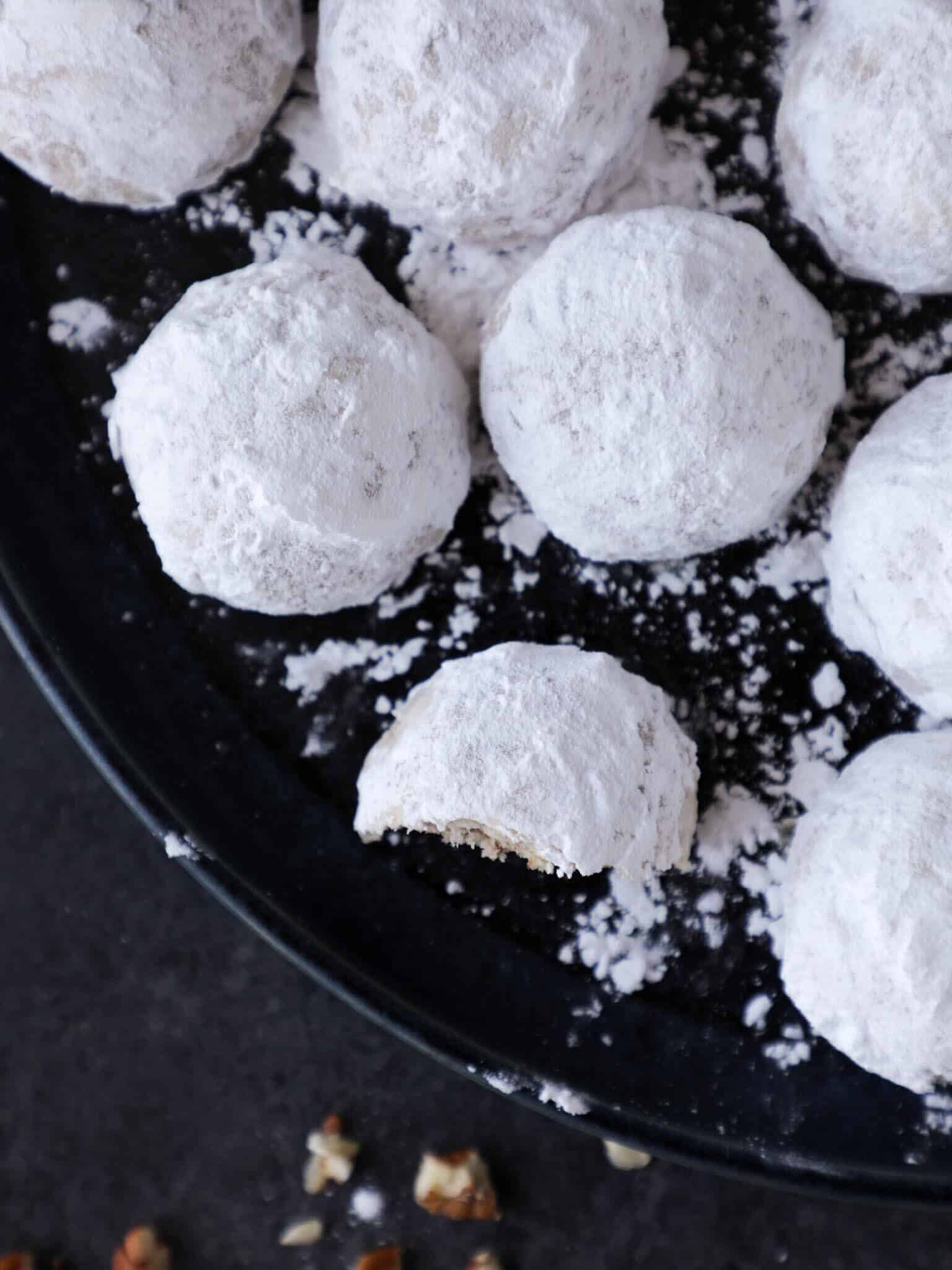 Snowball cookies covered in powdered sugar.