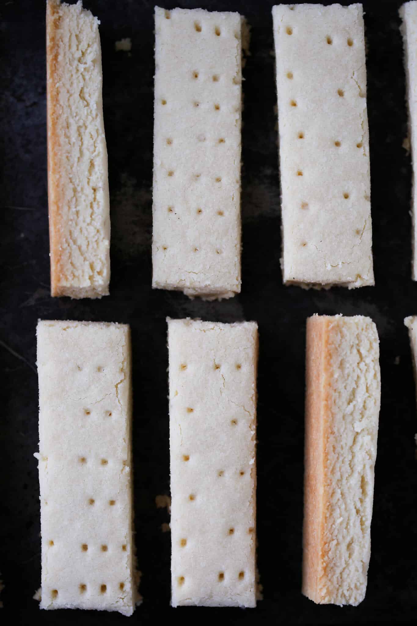 Scottish shortbread cut and placed on black background.