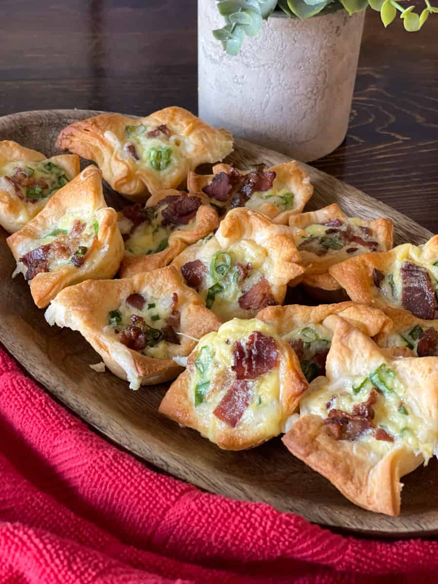 cheesy bacon crescent tartlets in wooden bowl.