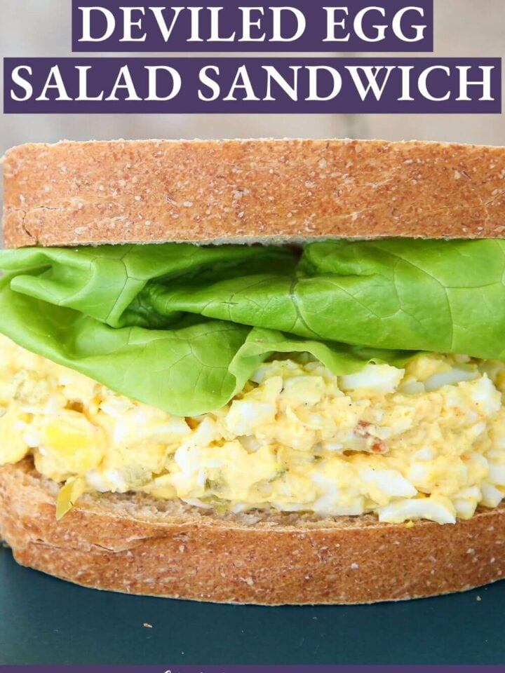 Assembled wheat bread, green lettuce, and deviled egg in a sandwich.
