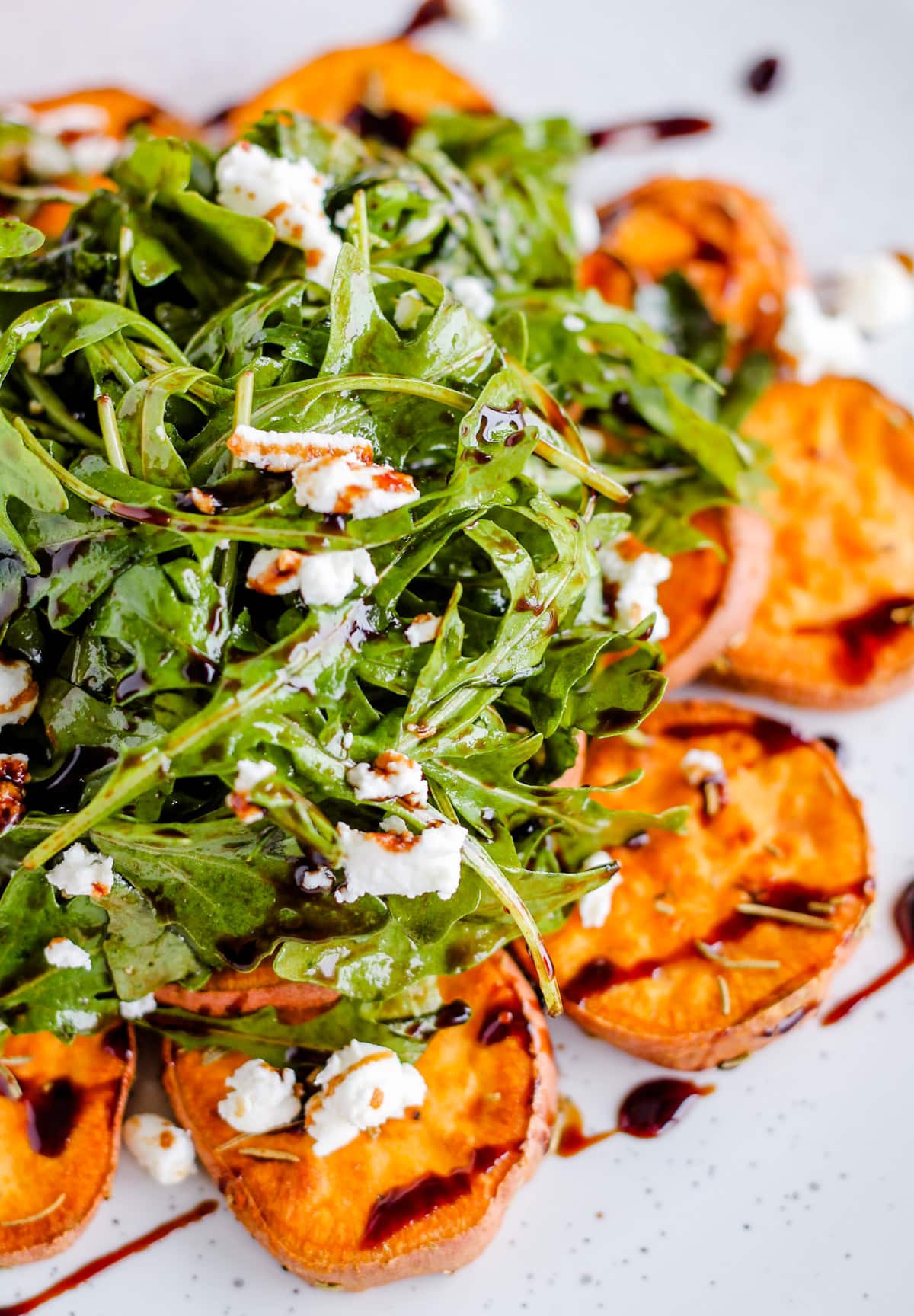 arugula salad with sweet potatoes and balsamic drizzle.