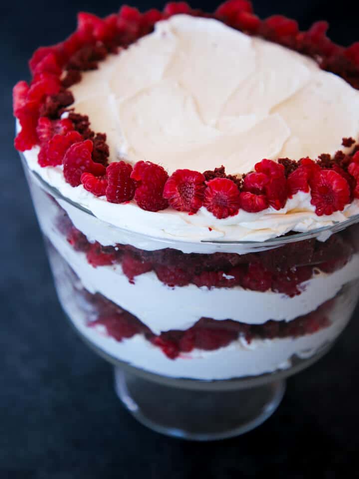 Red Velvet Raspberry Trifle in a clear bowl with red and white layers for Valentine's Day Desserts.