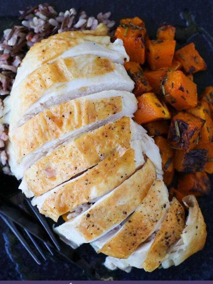 sliced roasted chicken breast on vegetables.