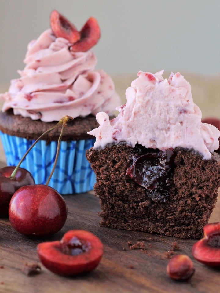 Double Chocolate Cupcakes Cherry Mascarpone Frosting with one half open showing its filling for  Valentine's Day Desserts.