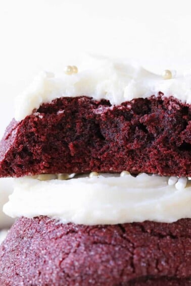 The inside of a red velvet cookie stacked on top of another red velvet cookie.