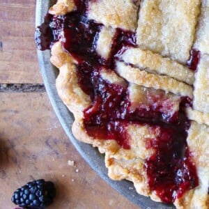 Mixed Berry Pie with dark berry filling bubbling through a lattice top.