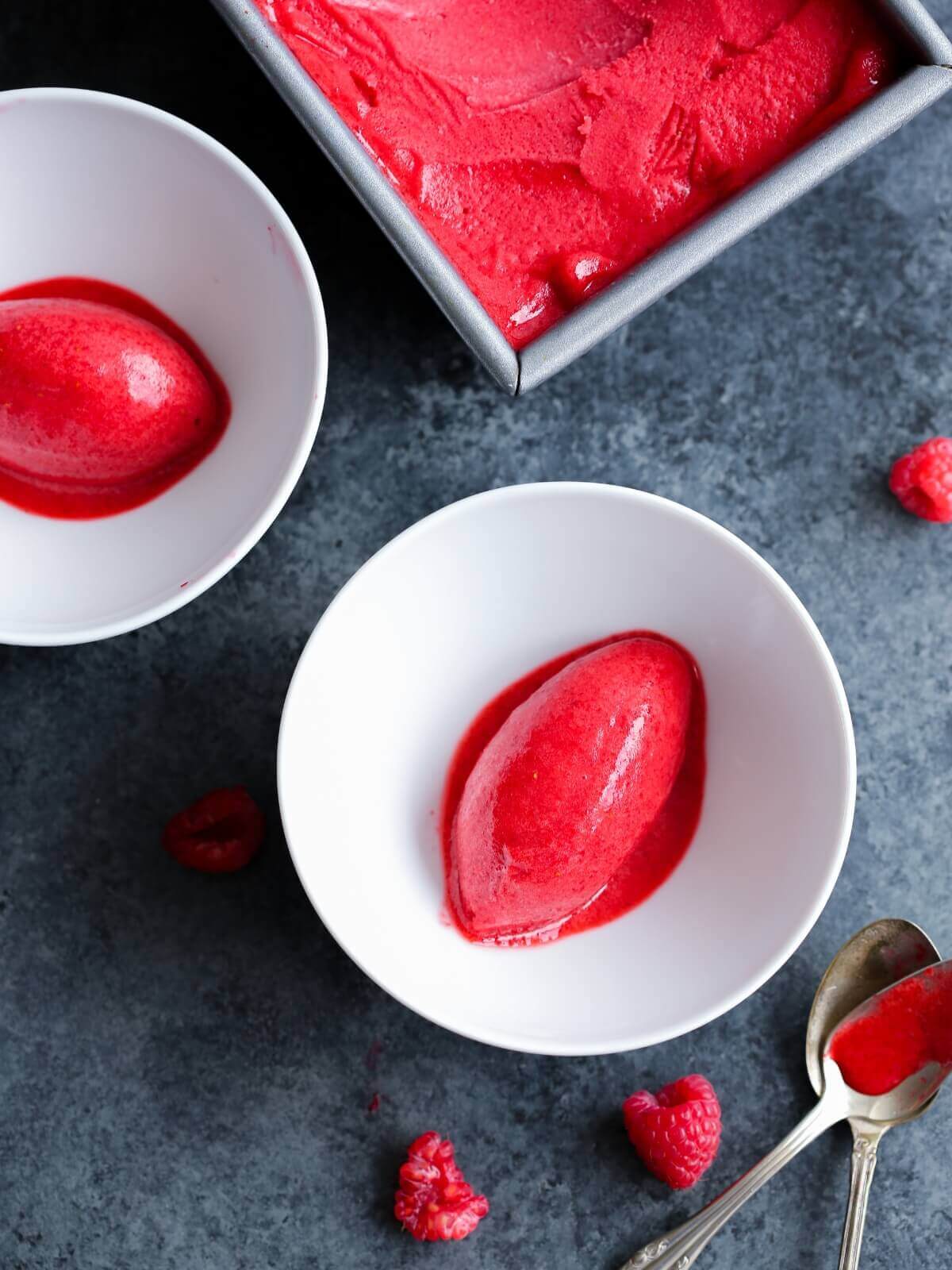 Raspberry sorbet served in two white bowls.