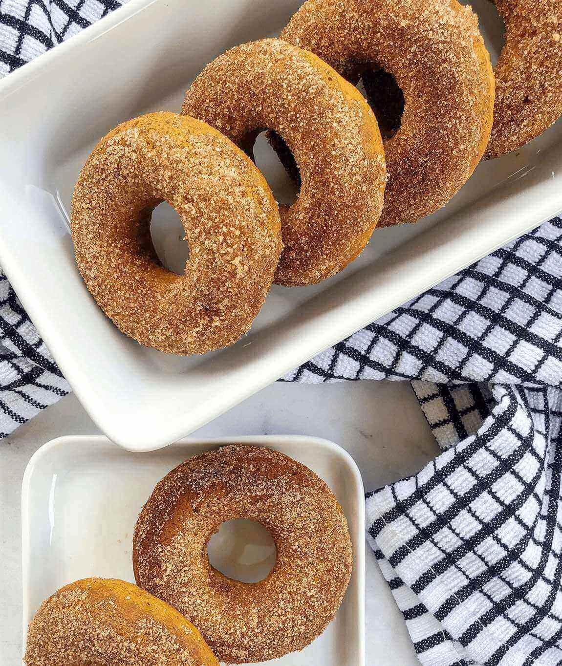 pumpkin donuts with sugar coating on plate.