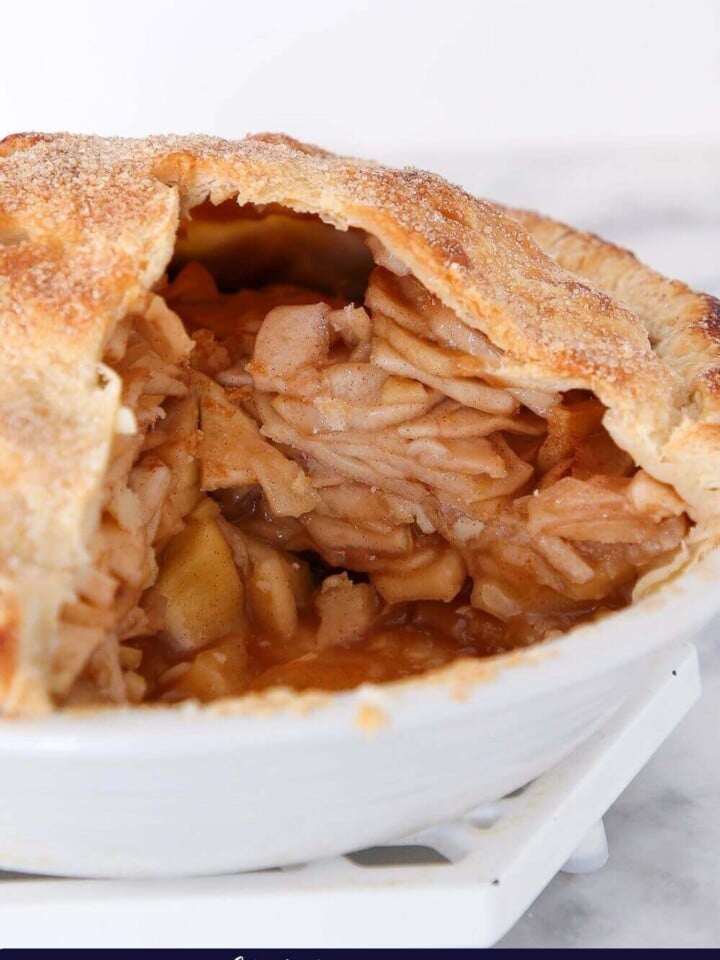 Apple pie in white pie dish.