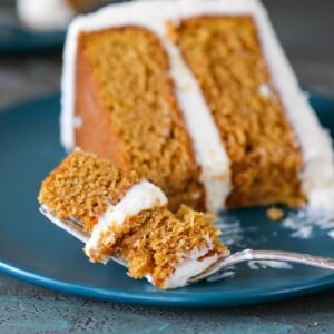 A piece of pumpkin cake on a blue plate.