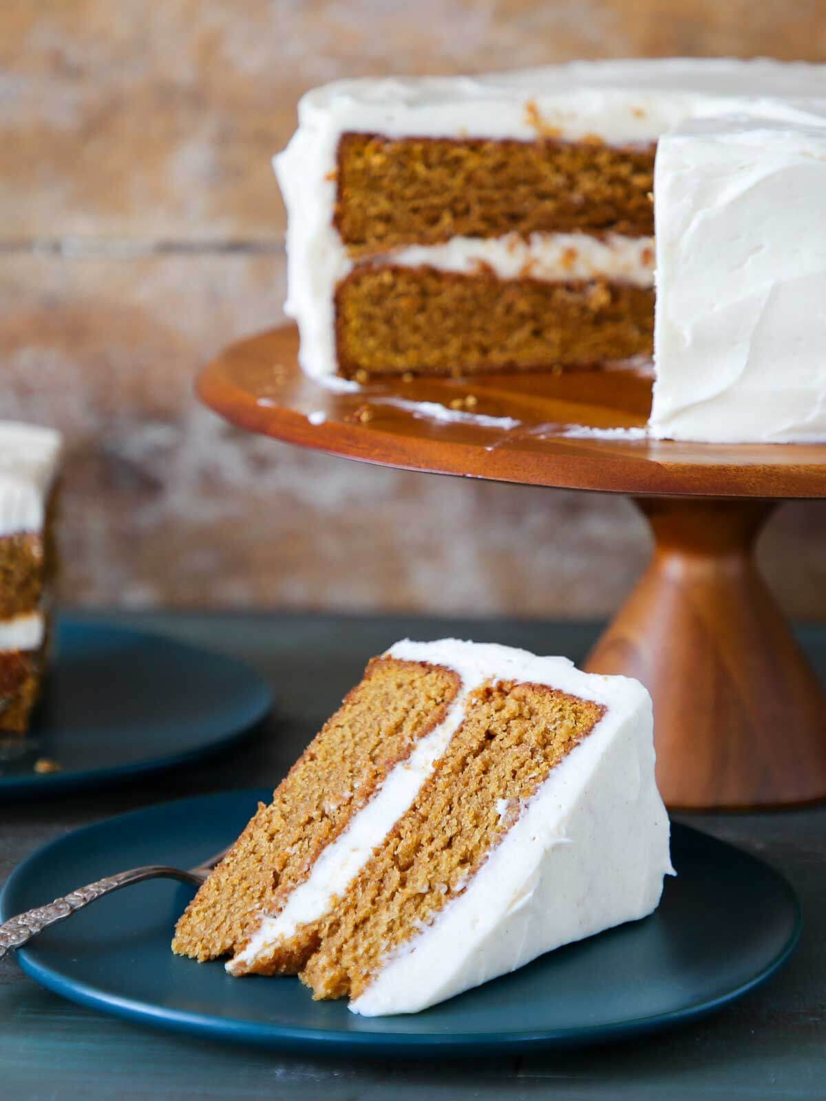 A whole pumpkin cake with a plated slice ready for eating.