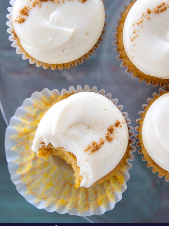 Pumpkin spice cupcakes with frosting on top.