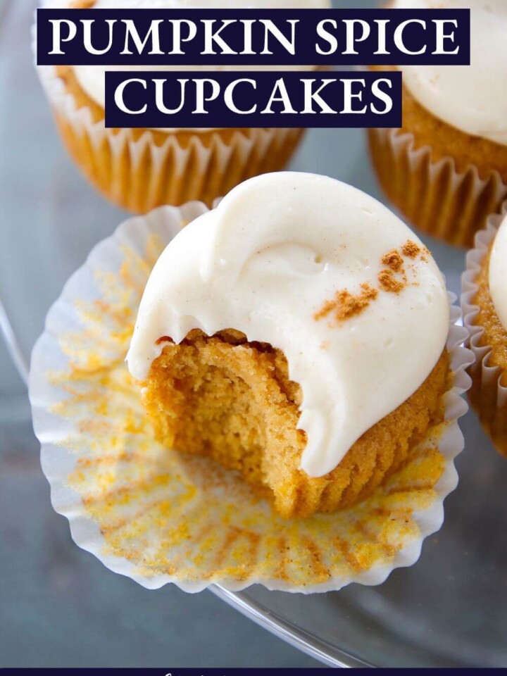 A pumpkin spice cupcake with a bite taken out of it.