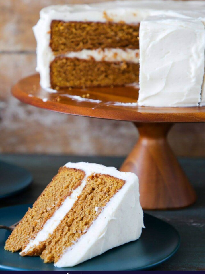 Pumpkin spice layer cake with a slice served on a plate.