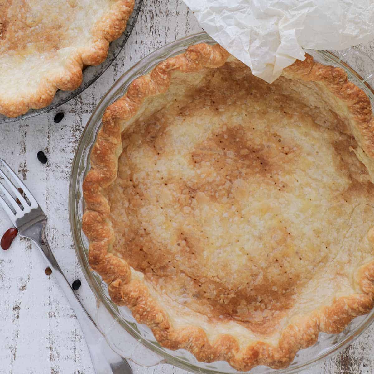 blind baked pie crust on white background.