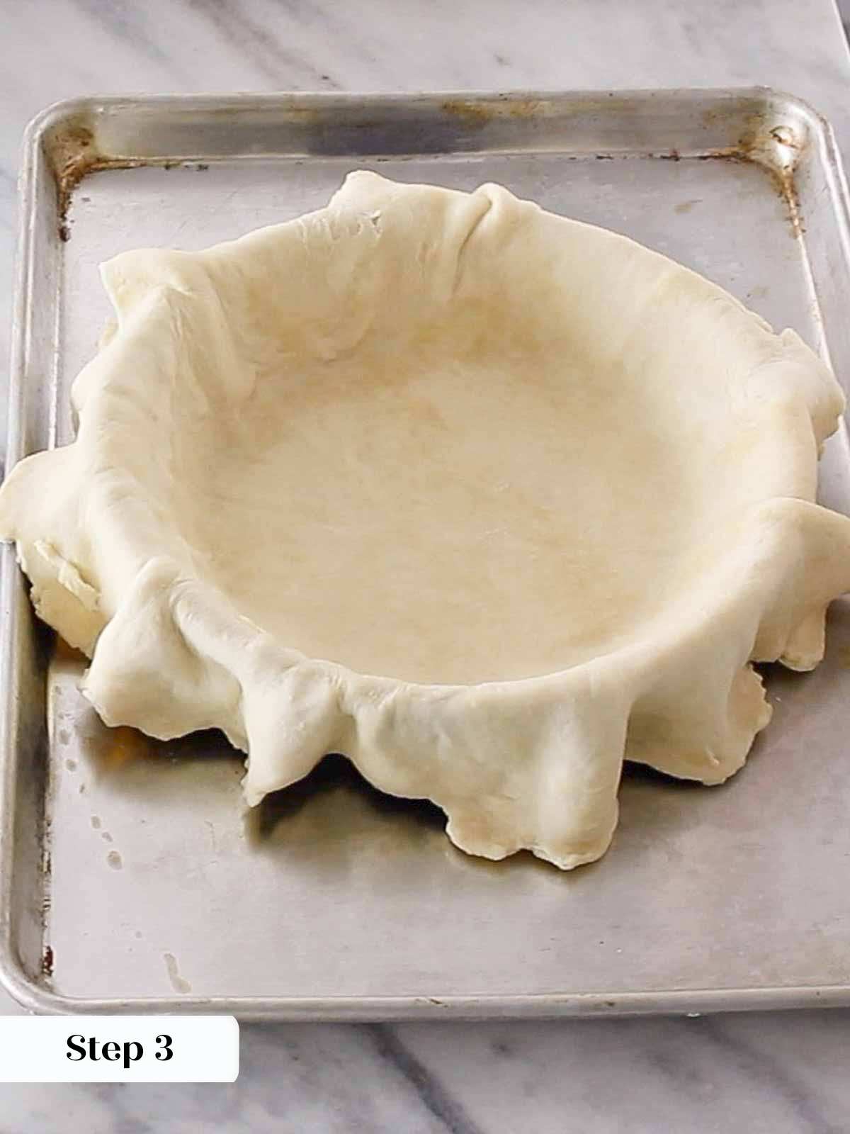 overlapping pie dough in pie plate.