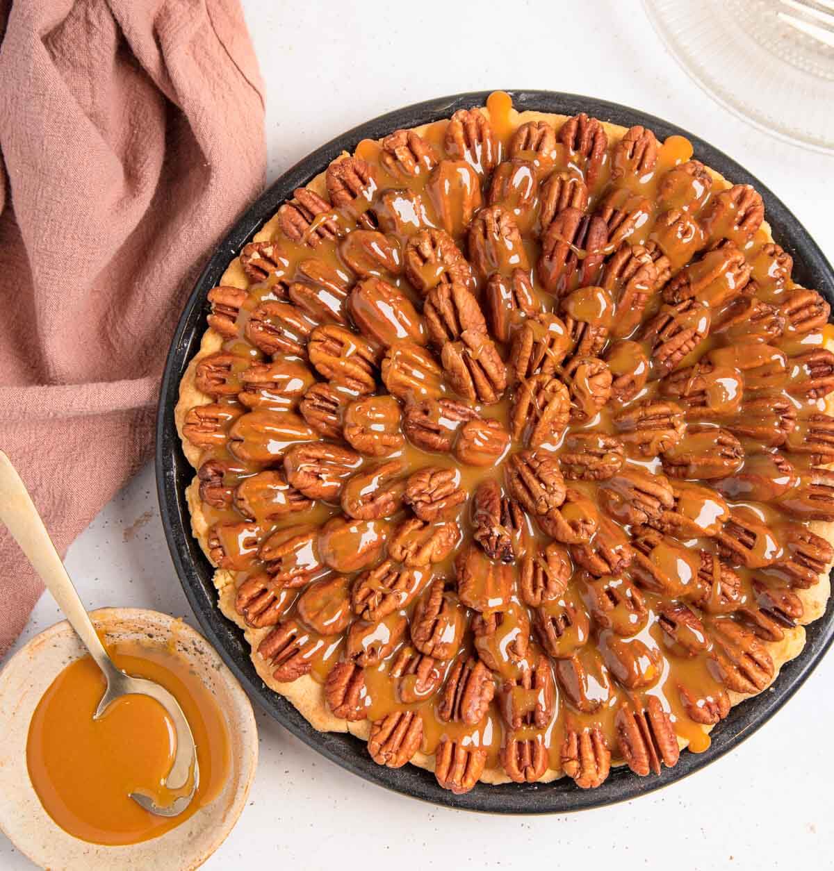 Chocolate pecan pie with a caramel sauce topping.