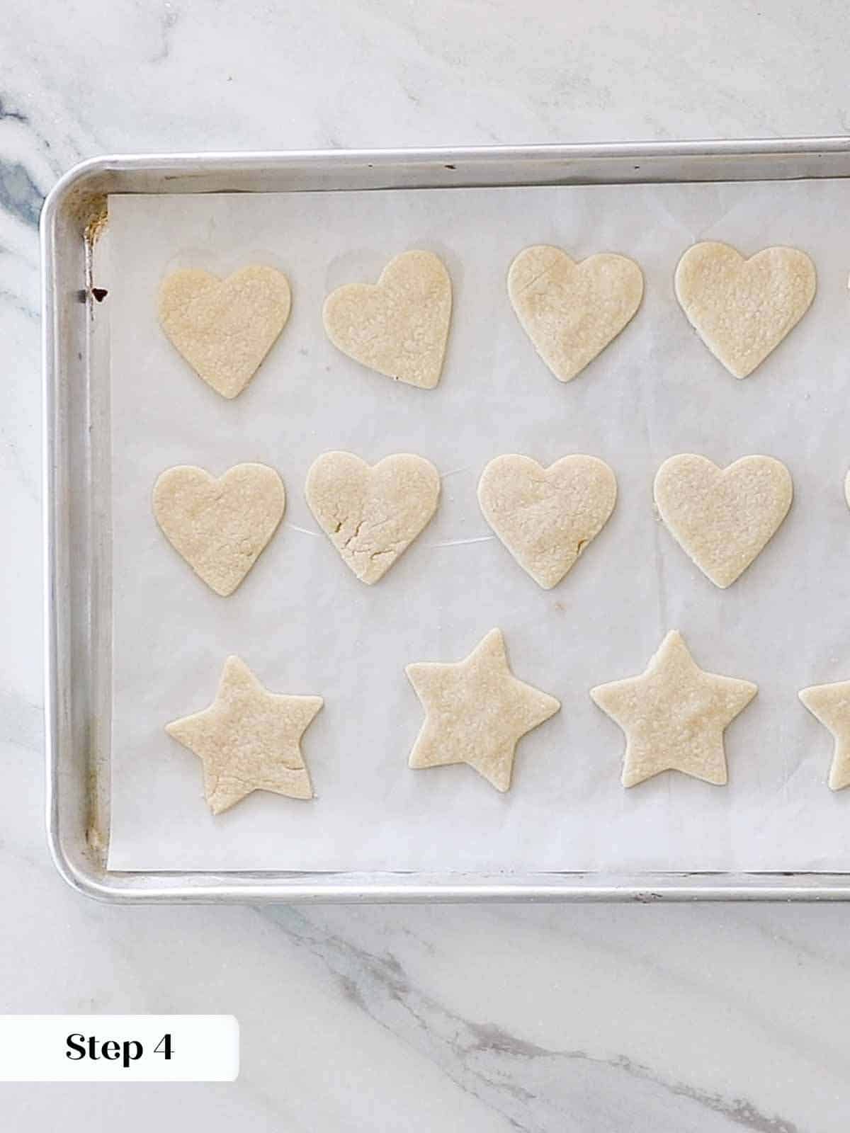 baked heart shaped sugar cookies on baking sheet.