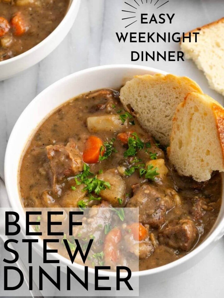 beef stew in white bowl with bread.