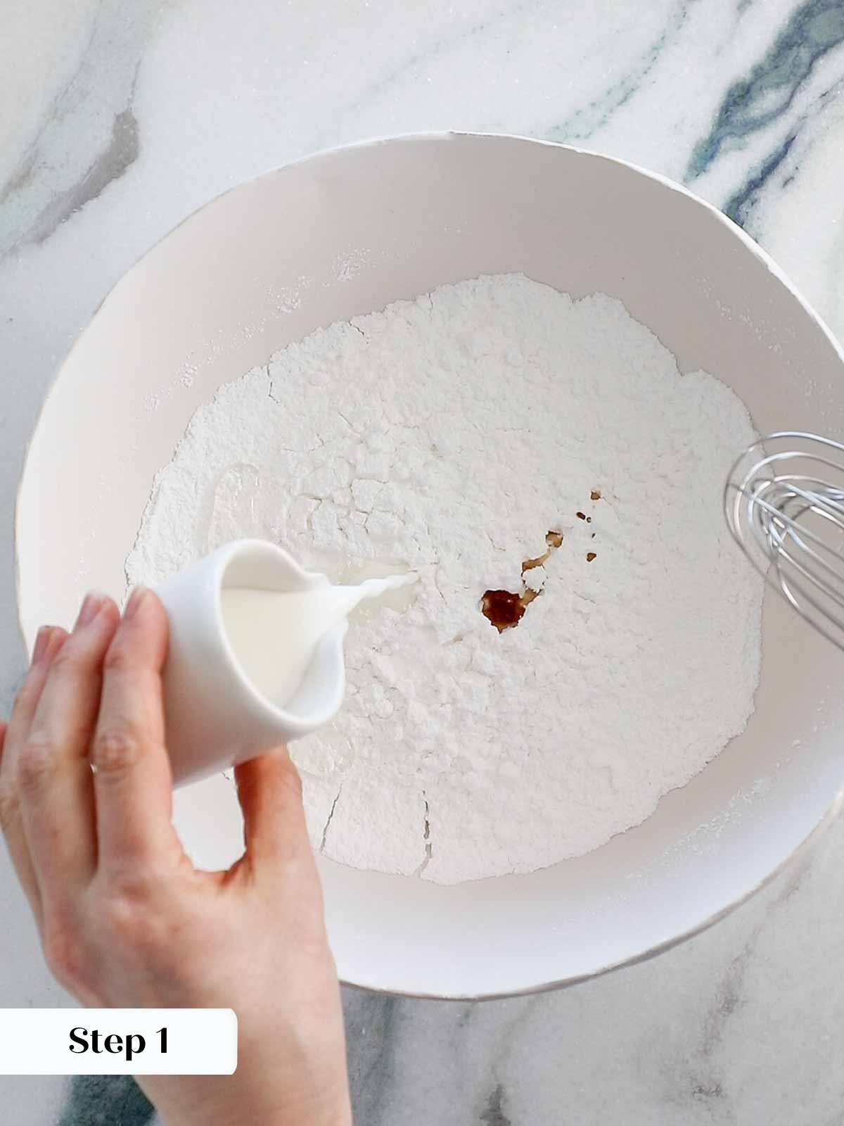 adding all ingredients to white bowl for icing.