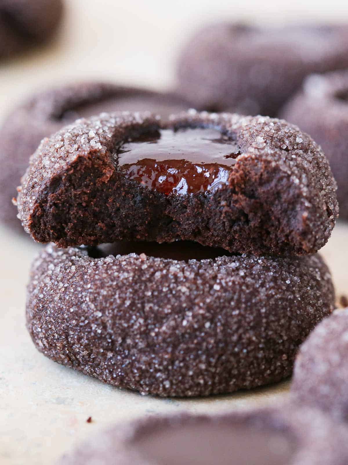 jam filled chocolate thumbprint cookies stacked.