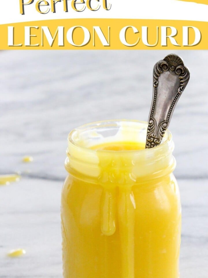 Lemon curd with a silver spoon.