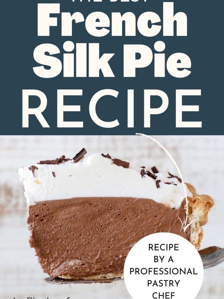 slice of silk pie viewed from the side with flaky crust, chocolate mousse filling and whipped cream topping.