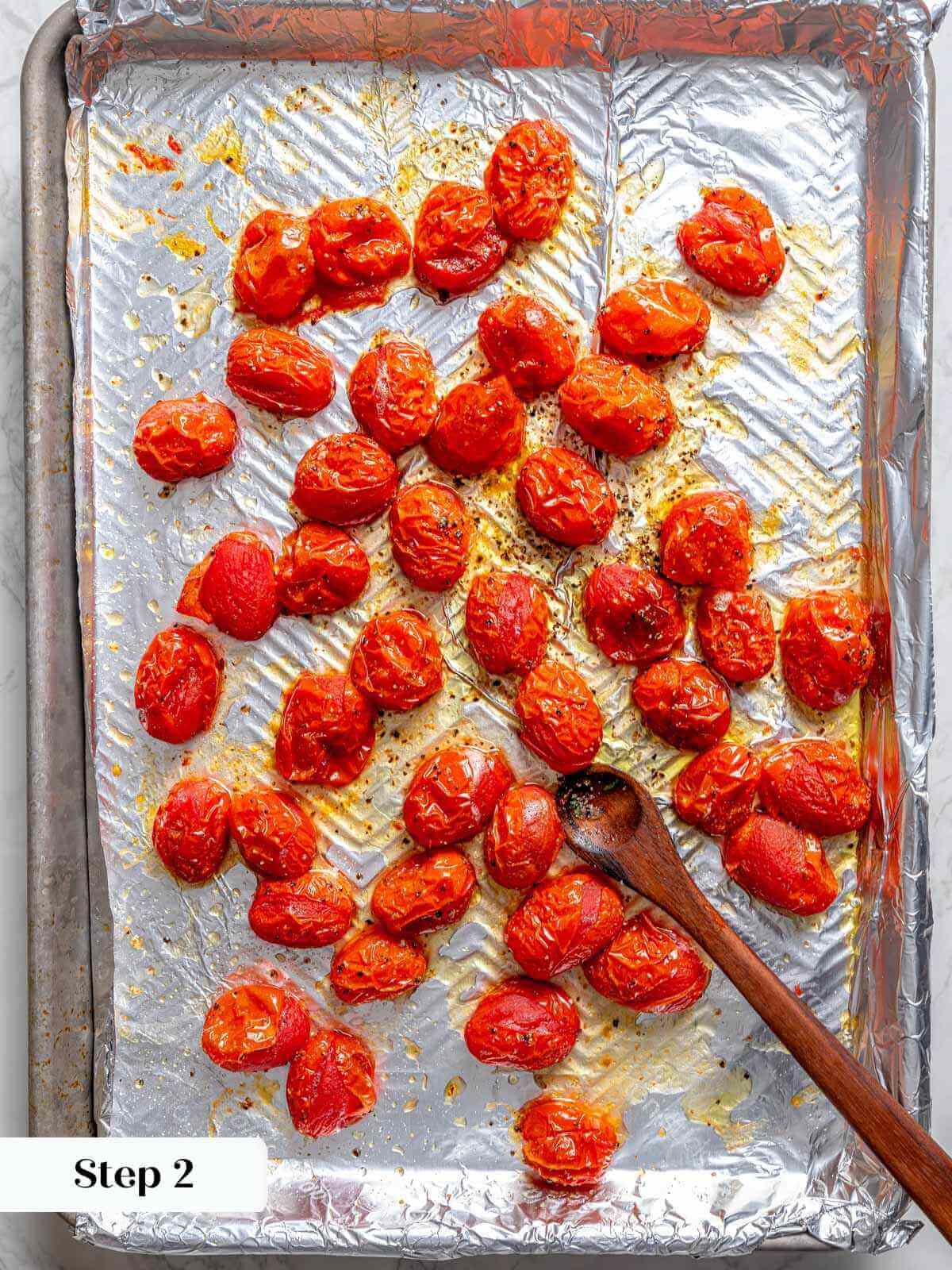 slow roasted tomatoes on foil lined baking sheet.