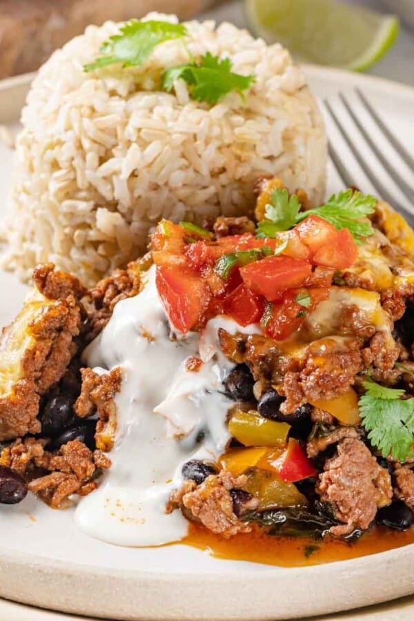 taco bake on white plate with rice.