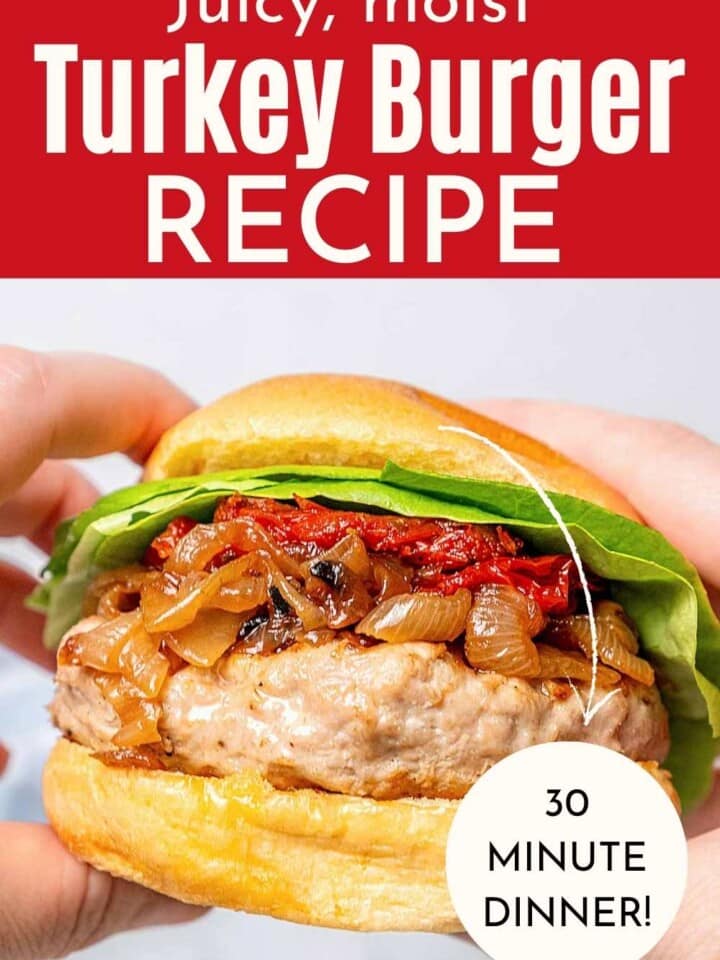 turkey burger on bun in hands.