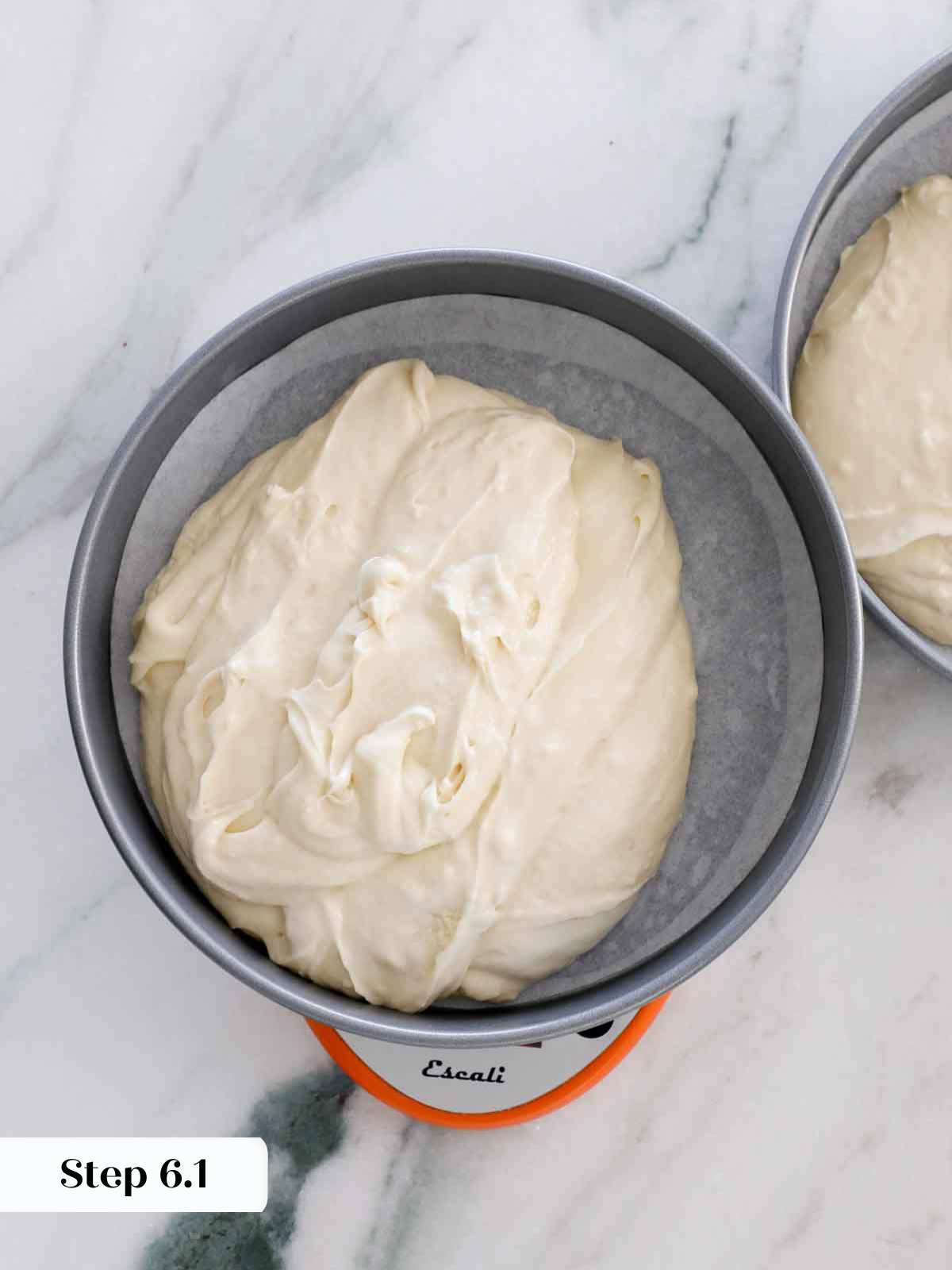 dividing batter between cake pans.