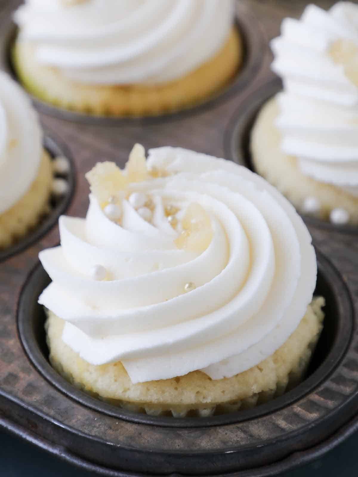 piped lemon buttercream frosting on cupcakes. 