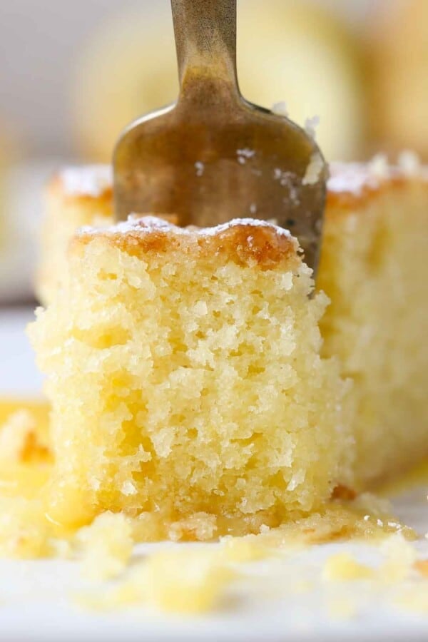 close up of lemon olive oil cake on gold fork.