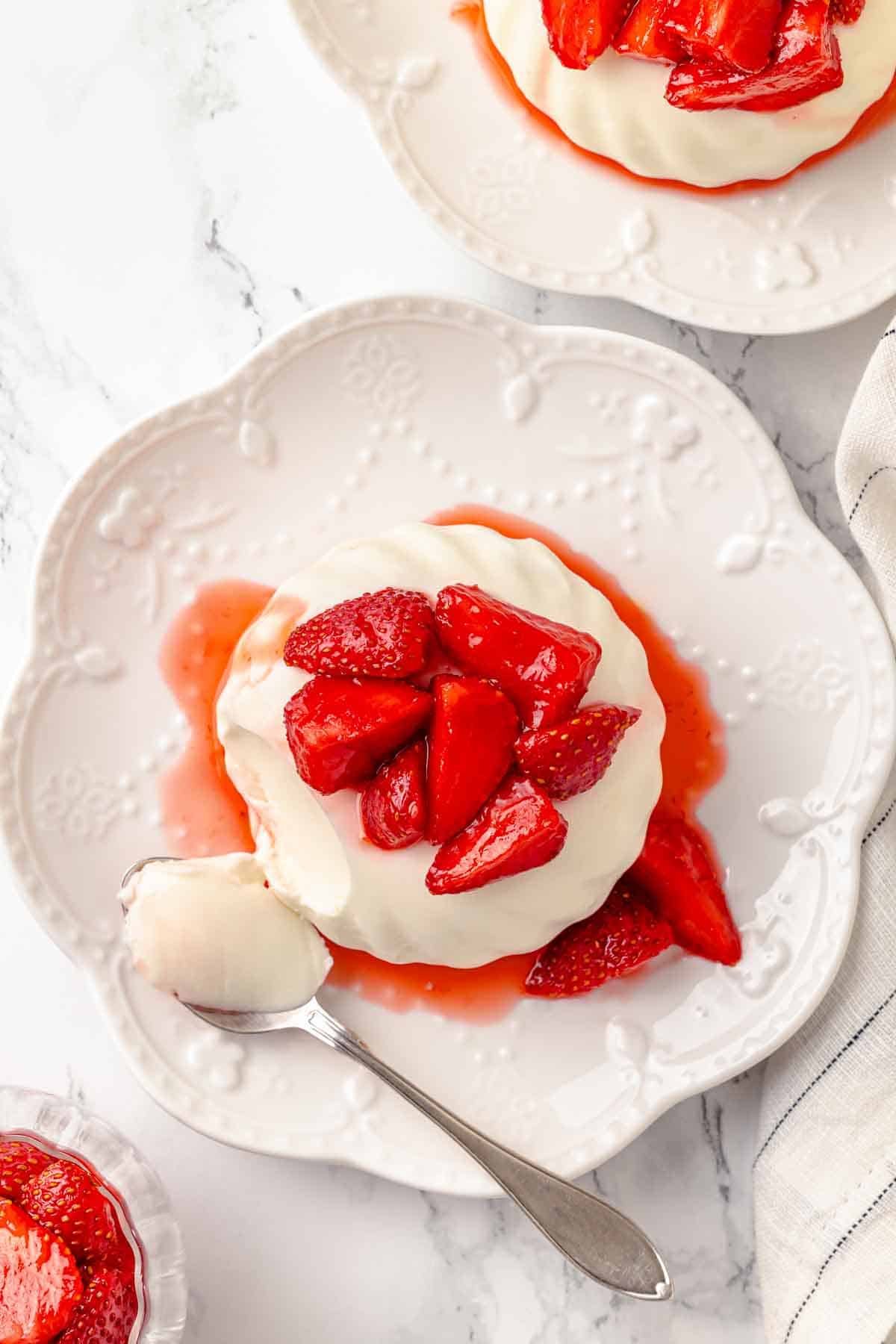 buttermilk panna cotta with macerated strawberries overhead.