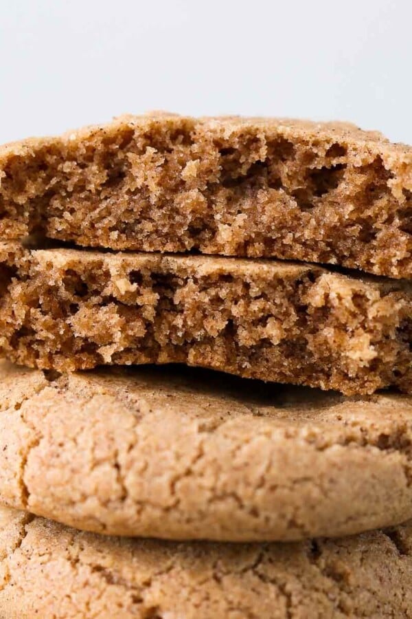 A cinnamon sugar cookie broken in half, showing the inside texture.