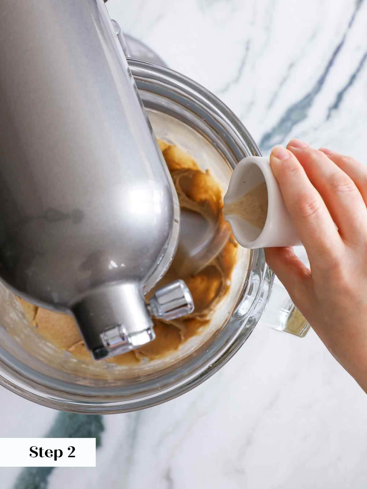 Adding eggs and vanilla to the cinnamon sugar cookie dough mixture.